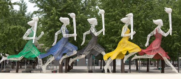 Sculptures of women running with Olympic torches in Beijing, China. © Sam Balye/Unsplash