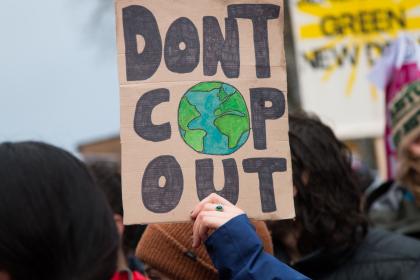 Demonstrators raise placards at one of the protests outside COP26 in Glasgow, November 2021 ©Toby Parkes/Shutterstock/2070571724