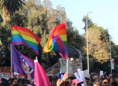 LGBTQ flags fly at a 8M march in Santiago, Chile