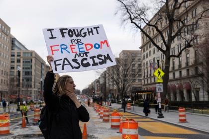 Protesters near the White House in Washington, D.C., USA, as street murals as dismantled behind. 14 March 2025. © Ashish Kiphayat | Shutterstock ID: 2615314669