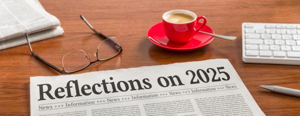 A newspaper on a wooden desk - Reflections on 2025 © Zerbor | Shutterstock ID: 2707617607