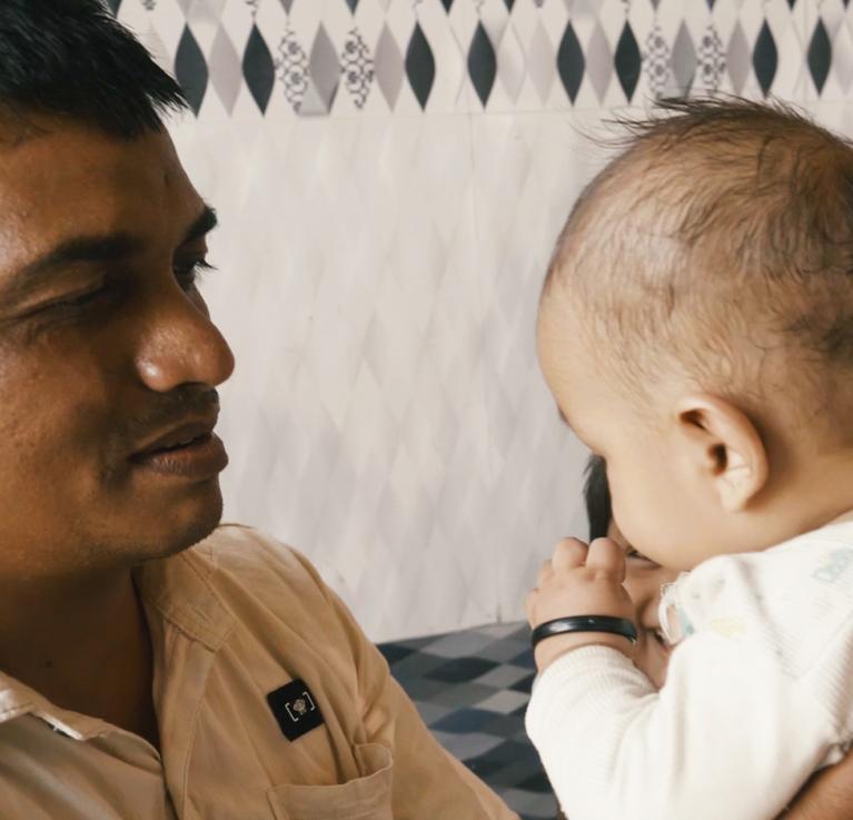 A family spending time with their child. A scene from the documentary film, Parwaaz | Flight (2020), produced by ICRW and directed by Mixed Media Productions © ICRW