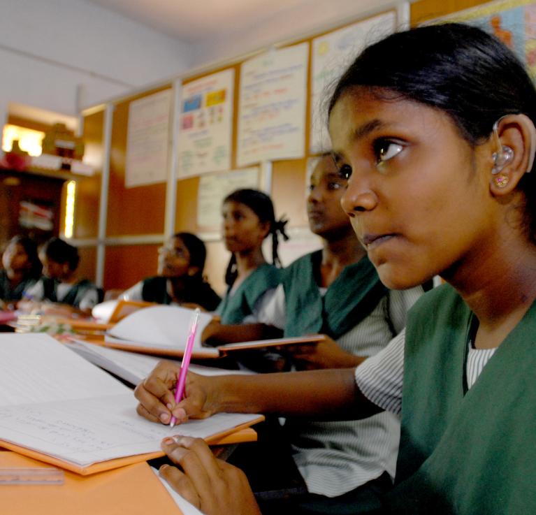 A girl with a hearing aid amongst peers at a school in Chennai, India. © Pippa Ranger/Department for International Development