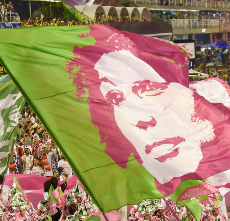 Flags of murdered Brazilian politician, Marielle Franco, waved during the Rio de Janeiro Carnival. Brazil, 2019. © Shutter Photo Press | Shutterstock