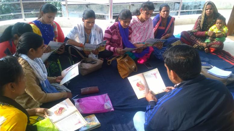 Village mentors preparing for group education session with adolescent girls, using the based on PAnKH Diary, in Dholpur, Rajasthan, India. © ICRW