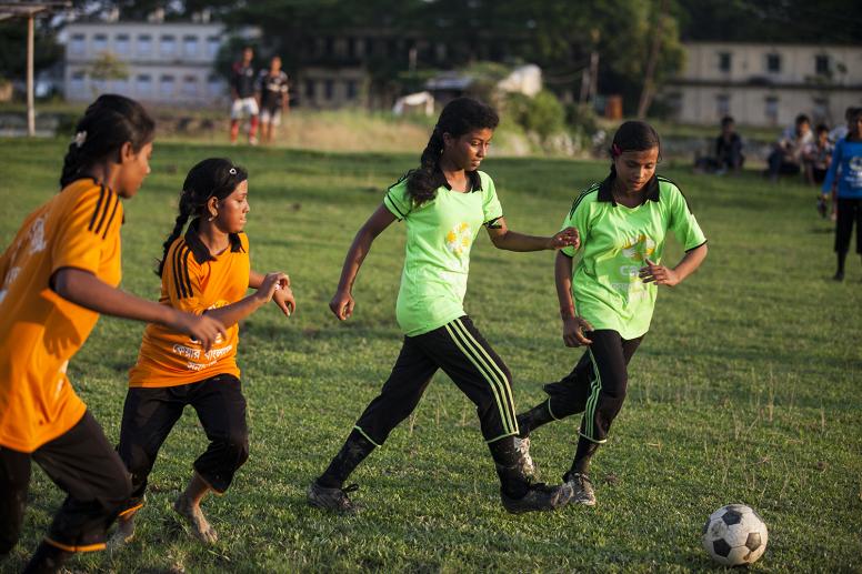 Girls playing football with support from the Tipping Point project
